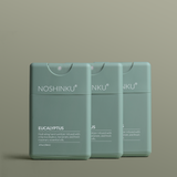 Three green Noshinku refillable Eucalyptus Hydrating Pocket hand sanitizer sprayers on a green background