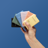 Hand holding all 6 of Noshinku Refillable Pocket Hand Sanitizers in Bergamot, Limon, Lavender, Eucalytus, Vetiver and Orange Coriander