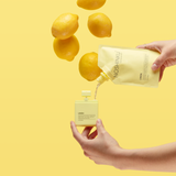 Noshinku Refillable Lemon Hydrating Pocket Hand Sanitizer being refilled on yellow backgorund